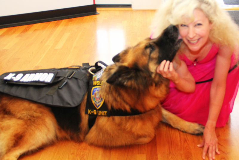 K-9 Armor Co-founder Suzanne Saunders and ESA K-9 Wolfie giving kisses of thanks for donations to protect Monterey Sheriff K9 Heroes. Photo by JelladianArt.com.