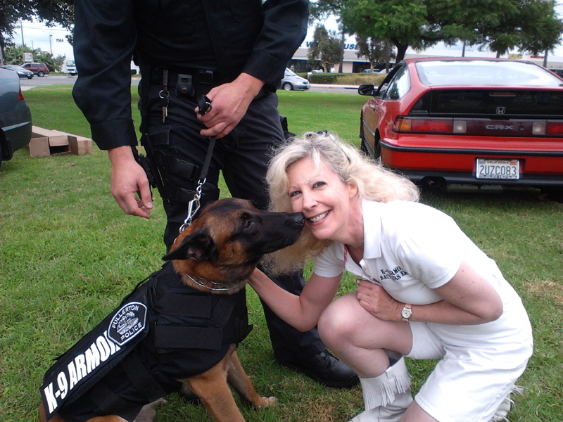 Fullerton PD K9 Mueller gives nose kisses of thanks to Suzanne Saunders, K-9 Armor Co-founder, photo by Tina Ortega North of Fullerton PD.