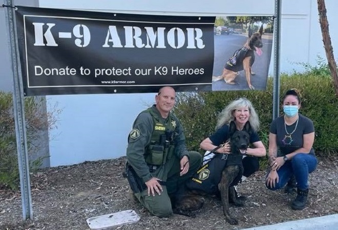 Hugs from Riverside County Sheriff Deputy Mushinskie and Jack, K9 Armor cofounder Suzanne and Amazon Manager Rosie Arias